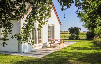 a picnic table in front of a white house at Cozy Apartment In Ranum With Wifi in Ranum