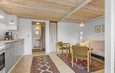 a kitchen and living room with a table and chairs at Cozy Apartment In Ranum With Wifi in Ranum