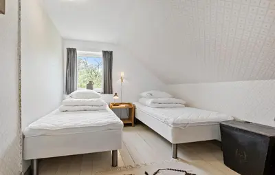 two beds in a white room with a window at 4 Bedroom Lovely Home In Ranum in Ranum