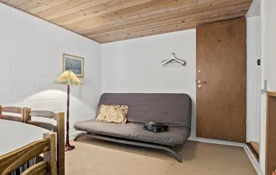 a couch in a room with a table and a lamp at 4 Bedroom Lovely Home In Ranum in Ranum