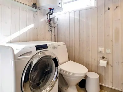 a washing machine in a bathroom with a toilet at Tranquil Beach Retreat - By Traum Ferienwohnungen in Løkken