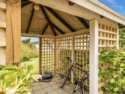 a bike parked inside of a wooden pavilion at Apartment Milly - 150m to the fjord by Interhome in Vestervig