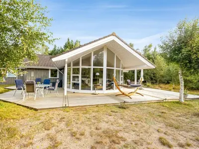 a screened in porch with a table and chairs on a deck at Holiday Home Guri - 600m to the fjord by Interhome in Fur