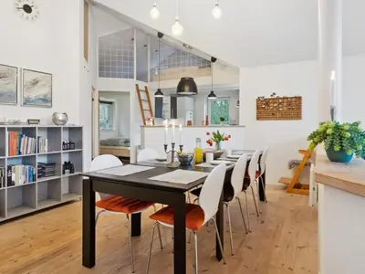 a dining room with a black table and chairs at Holiday Home Guri - 600m to the fjord by Interhome in Fur