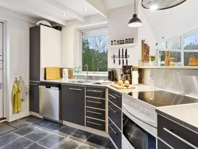 a kitchen with stainless steel appliances and a large window at Holiday Home Guri - 600m to the fjord by Interhome in Fur