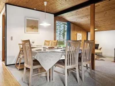 a dining room with a table and chairs at Holiday Home Suri - 200m to the fjord by Interhome in Thyholm