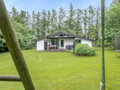 a small white house with a yard at Holiday Home Suri - 200m to the fjord by Interhome in Thyholm
