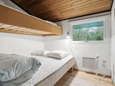a bedroom with a bed and a window at Holiday Home Suri - 200m to the fjord by Interhome in Thyholm