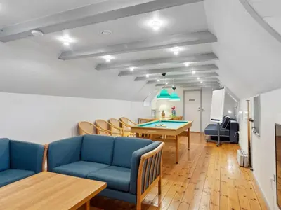 a living room with blue chairs and a table at Holiday Home Annli - 800m to the fjord by Interhome in Fur