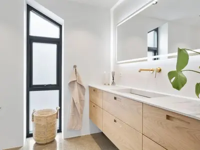 a bathroom with a large mirror and a sink at Holiday Home Ilja - 800m from the sea by Interhome in Blokhus