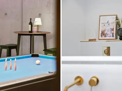 a room with a pool table and a table with a bottle of wine at Holiday Home Ilja - 800m from the sea by Interhome in Blokhus
