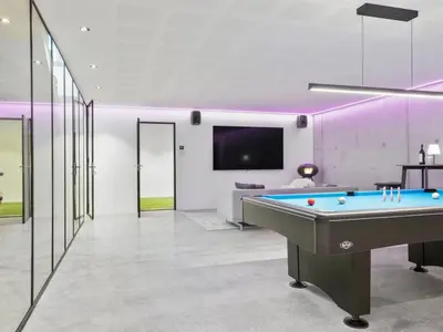 a pool table in a living room with purple lighting at Holiday Home Ilja - 800m from the sea by Interhome in Blokhus