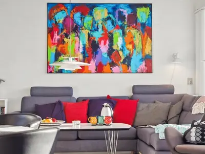 a living room with a couch and a painting on the wall at Holiday Home Leny - 900m from the sea by Interhome in Pandrup