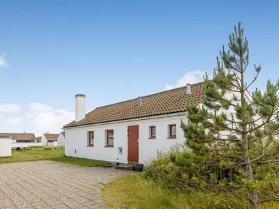 a white house with a tree in front of it at Holiday Home Leny - 900m from the sea by Interhome in Pandrup