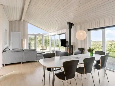 a dining room with a table and chairs at Holiday Home Mirla - 50m from the sea by Interhome in Saltum