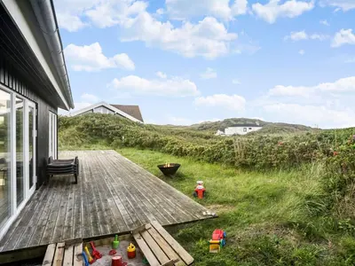 a deck with a view of the ocean from a house at Holiday Home Mirla - 50m from the sea by Interhome in Saltum