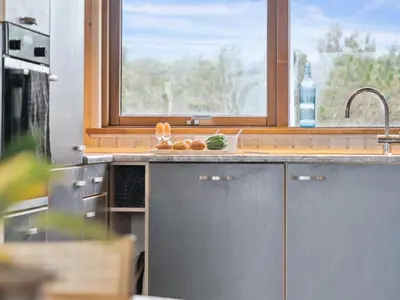 a kitchen with a sink and a window at Holiday Home Gidske - 300m from the sea by Interhome in Blokhus