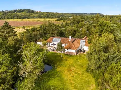 an aerial view of a house with a pond at Holiday Home Verner - 900m from the sea by Interhome in Fjerritslev
