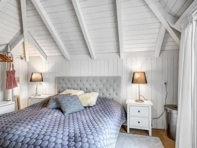 a bedroom with a blue bed with two night stands at Holiday Home Verner - 900m from the sea by Interhome in Fjerritslev