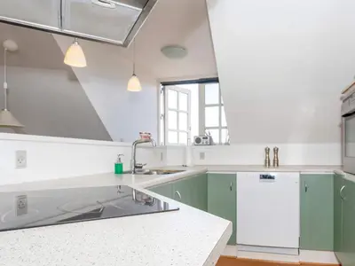 a kitchen with green cabinets and a sink at 4 star holiday home in Thisted-By Traum in Thisted