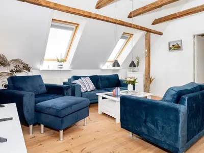 a living room with blue furniture and wooden floors at 4 star holiday home in Thisted-By Traum in Thisted