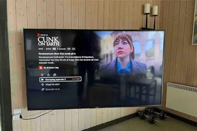 a flat screen tv hanging on a wall at Veludstyret sommerhus i unik natur 350 m fra lækker badestrand - helårsbolig in Saltum