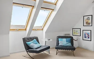 two chairs and a table in a room with windows at Amazing Home In Harboøre With Kitchen in Harboør
