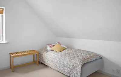 a bedroom with a bed and a small table at Amazing Home In Harboøre With Kitchen in Harboør
