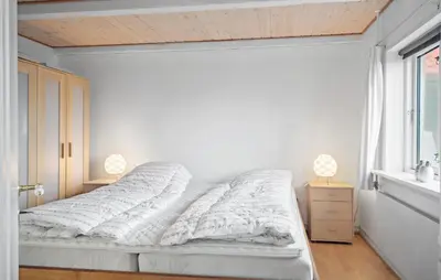 a white bedroom with a bed and a window at Amazing Home In Harboøre With Kitchen in Harboør