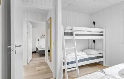 a bedroom with two bunk beds and a mirror at Stunning Home In Løgstrup With Kitchen in Løgstrup