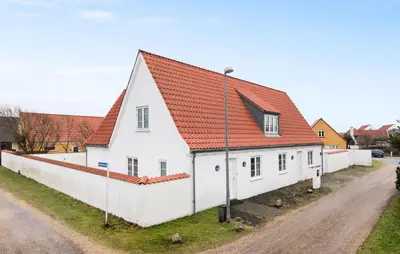 a white house with an orange roof at Amazing Home In Blokhus With Kitchen in Blokhus
