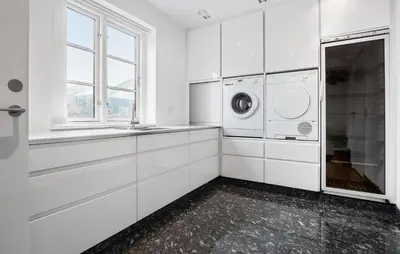 a white laundry room with a washer and dryer at Amazing Home In Blokhus With Kitchen in Blokhus