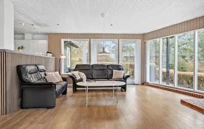 a living room with two leather chairs and a table at 3 Bedroom Pet Friendly Home In Højslev in Højslev