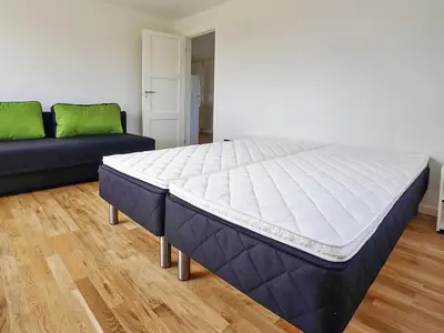 a large bed in a room with a couch at Holiday Home Mirja - 50m to the fjord by Interhome in Fur