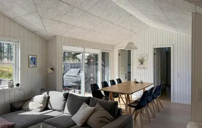 a living room with a couch and a table and chairs at 3 Bedroom Cozy Home In Thisted in Thisted