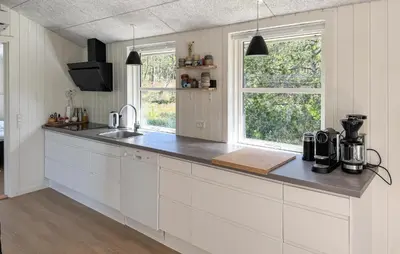 a white kitchen with a counter top and two windows at 3 Bedroom Cozy Home In Thisted in Thisted