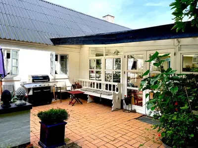 a patio of a house with a bench in it at pallisgaard B&B in Struer