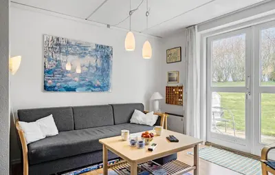 a living room with a couch and a table at 2 Bedroom Nice Apartment In Lemvig in Lemvig
