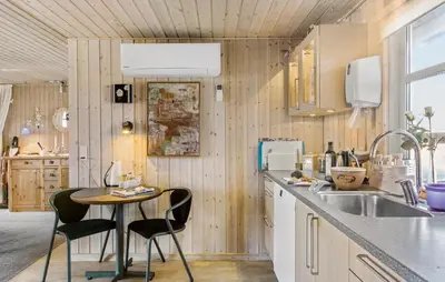 a kitchen with a table and chairs and a sink at 4 Bedroom Beautiful Home In Pandrup in Pandrup