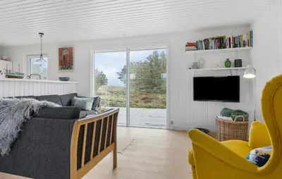 a living room with a couch and a tv at Awesome Home In Brovst With Wifi in Brovst