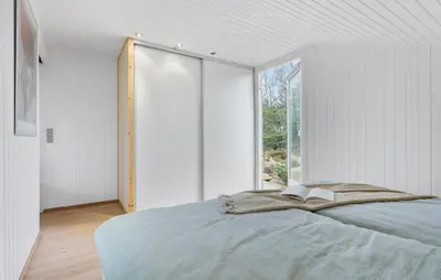 a bedroom with a bed and a large window at Awesome Home In Brovst With Wifi in Brovst