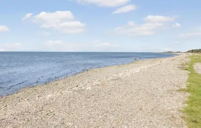 a rocky beach with the ocean in the background at Nice Home In Hurup Thy With Wifi in Sindrup