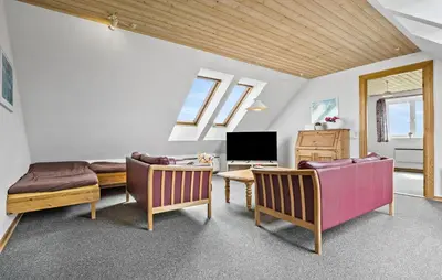 a living room with two couches and a tv at Cozy Home In Frøstrup With Sauna in Frøstrup