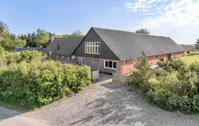 a large brick house with a black roof at Pet Friendly Apartment In Vestervig in Vestervig