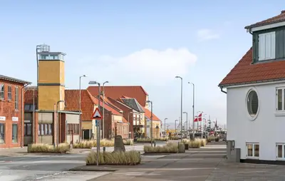 a street in a town with buildings and street lights at 1 Bedroom Nice Apartment In Thyborøn in Thyborøn