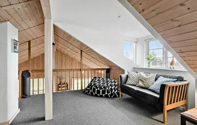a living room with a black couch and wooden ceilings at 3 Bedroom Pet Friendly Home In Højslev in Højslev