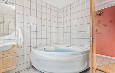 a white bathroom with a tub and a sink at 3 Bedroom Awesome Home In Vestervig in Vestervig