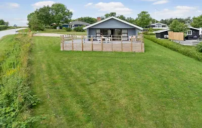 a house in the middle of a grass field at 3 Bedroom Stunning Home In Hurup Thy in Doverodde