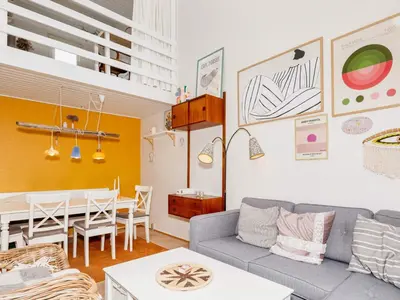 a living room with a couch and a dining room at 6 person holiday home in Vestervig-By Traum in Vestervig