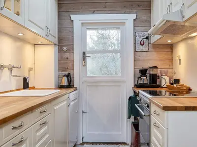 a kitchen with white cabinets and a white door at 5 person holiday home in Vesløs-By Traum in Øsløs